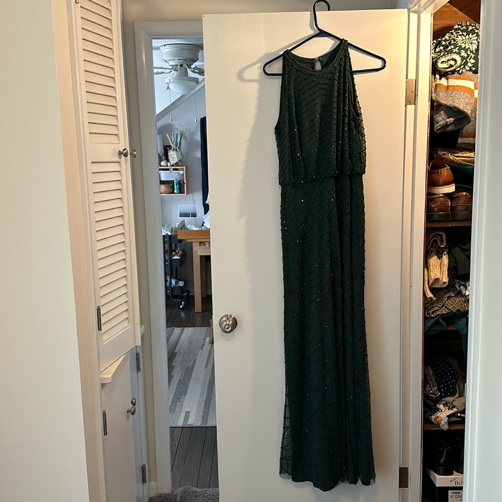 Floor length Adrianna Papeli Gown in emerald green with beading over entire gown